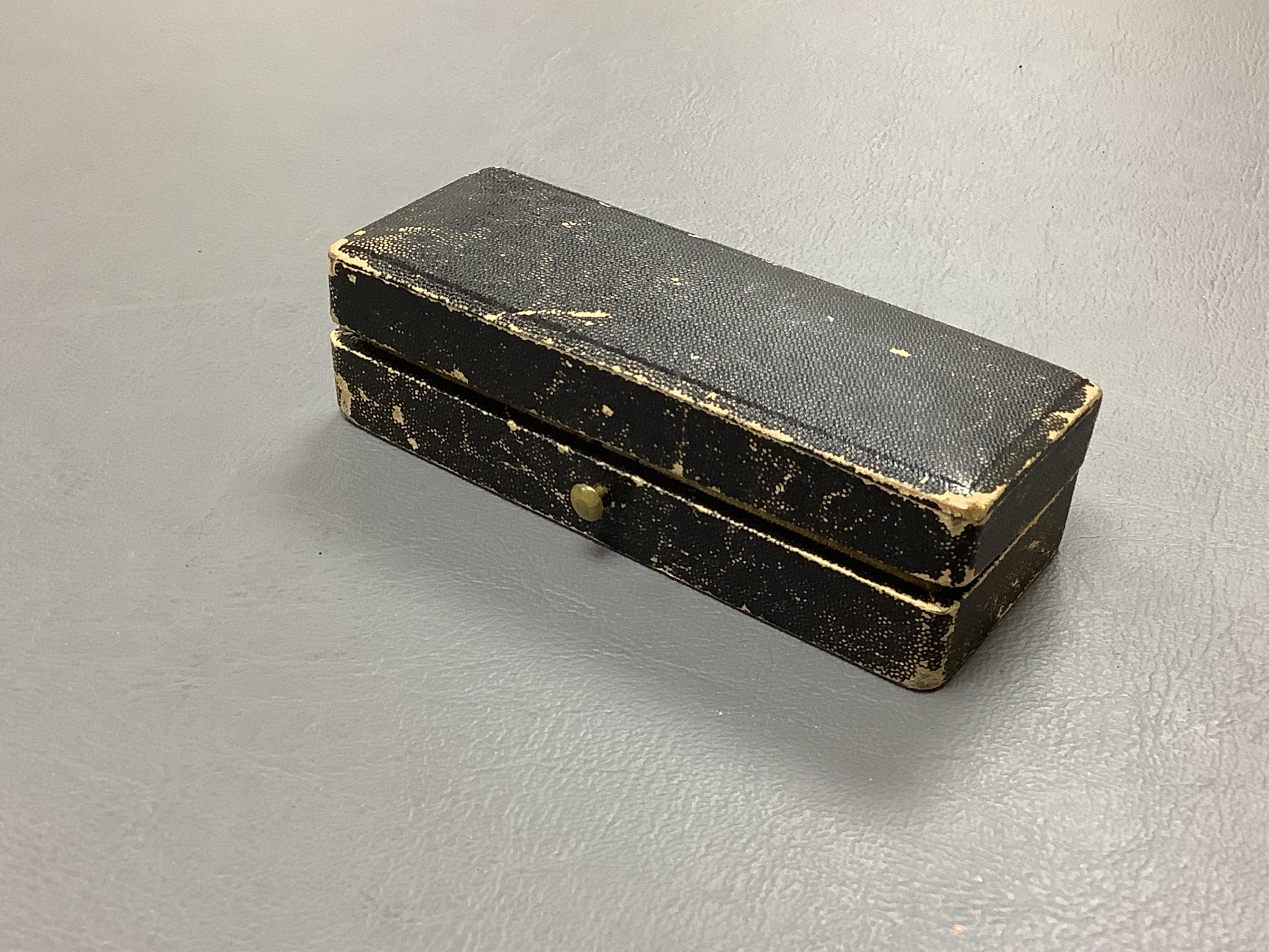A late 19th century cased group of three prosthetic glass eyes